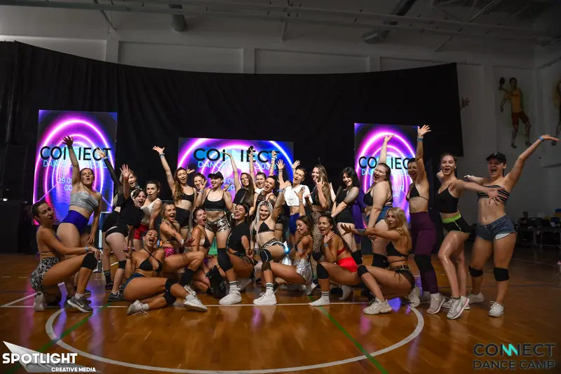 Twerk students dancing freely during the freestyle portion of a class while music plays loud through studio speakers — the third-song freestyle stage of a practice block